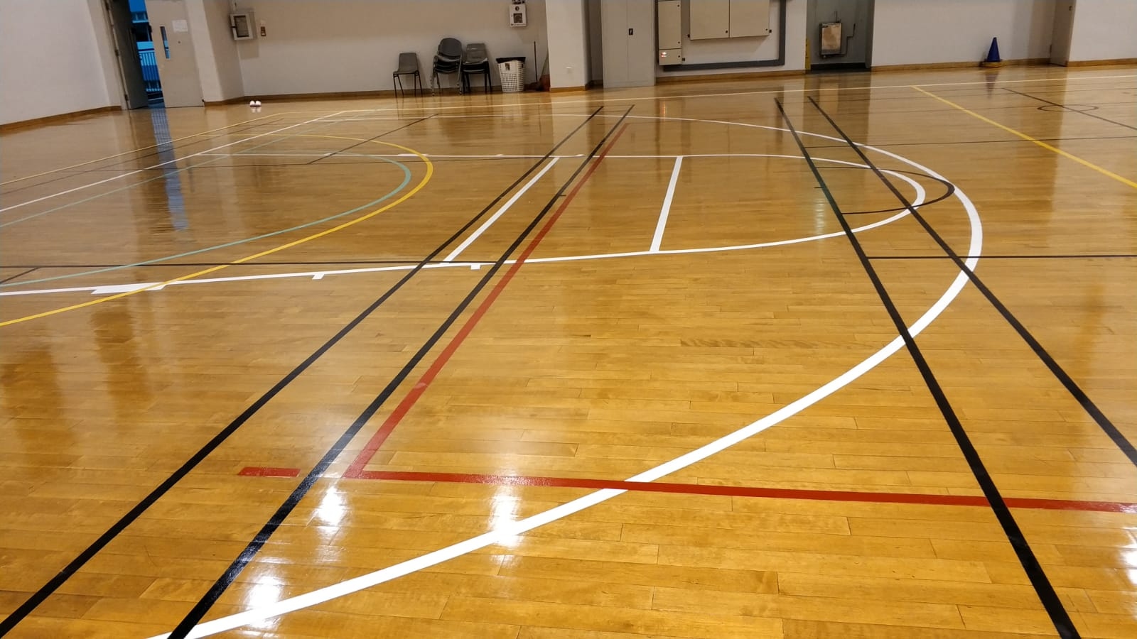 Multi-game court line marking on the timber sports floor at St Margaret Secondary School multi-purpose hall